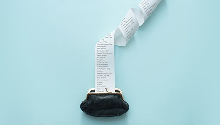 A purse with a receipt unfurling out of it, to show costs.
