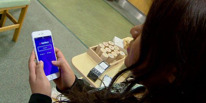 A person uses a smartphone to access online banking