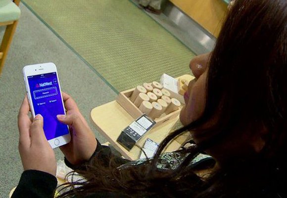A person uses a smartphone to access online banking