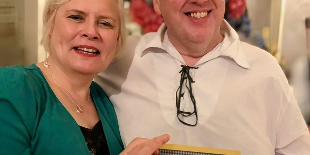 Yvonne Milne and Allan Russell from RNIB Connect Radio at the ARIAS, holding gold award for best community station.