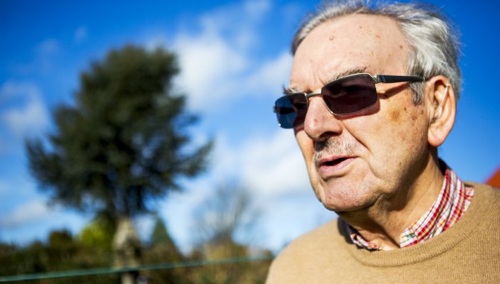 Older man, outside, wearing sunglasses.