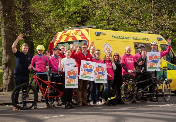 RNIB Volunteers standing in front of an ambulance with bicycles and signs that read "The Big Help Out"