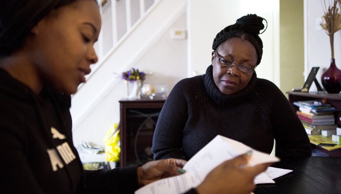 Two people discuss a document at a table
