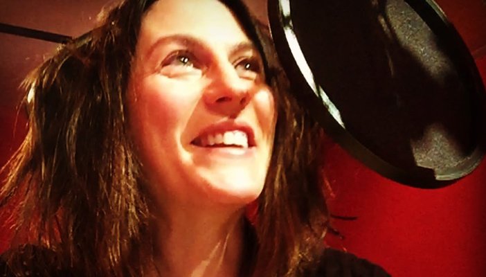 Talking Book narrator, Claire Morgan, talking into a microphone