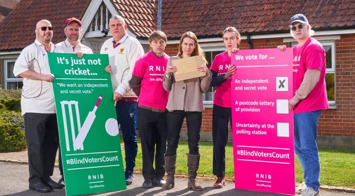 RNIB and Surrey County Cricket Club deliver a petition to Michael Gove, pictured is 7 adults holding signs saying "It's just not cricket" and "We vote for an independent and secret vote"