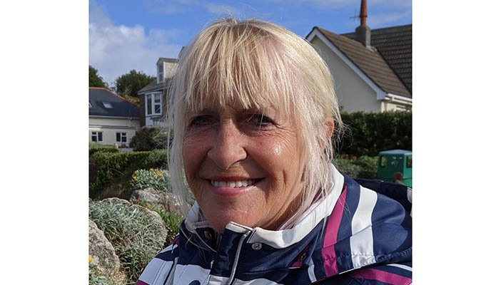 Elizabeth smiling at the camera while outside