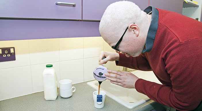 A man pouring a drink using a liquid level indicator.
