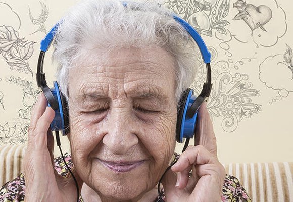 A lady wearing headphones with eyes closed in enjoyment.