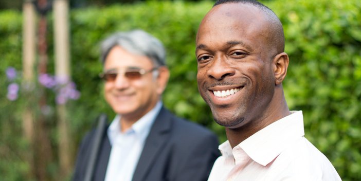 Photo showing diverse man with a blurred person in the back