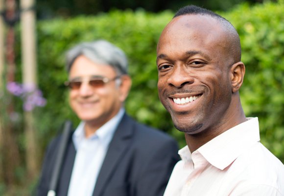 Photo showing diverse man with a blurred person in the back