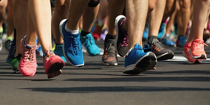 Close up of marathon runner’s trainers while running.