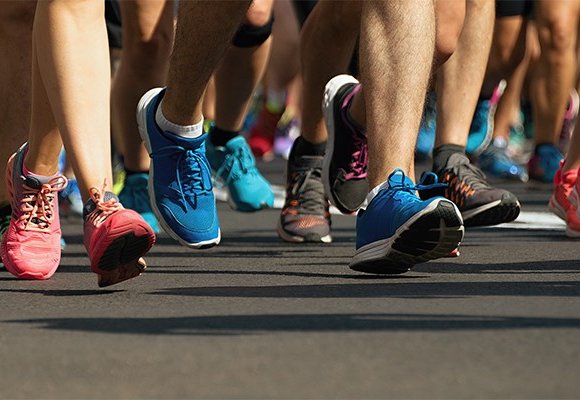 Close up of marathon runner’s trainers while running.