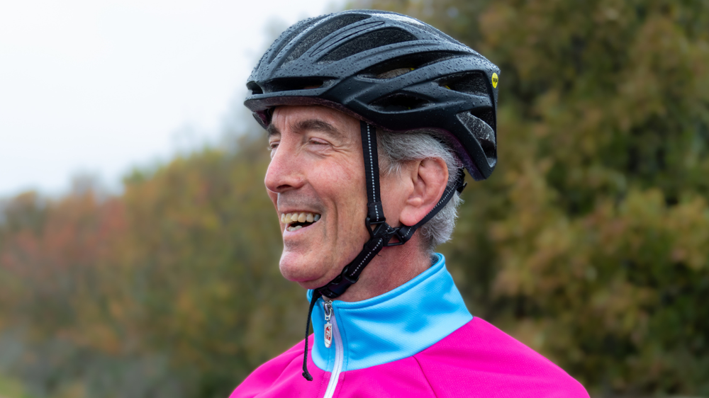 A man with a cycling helmet on