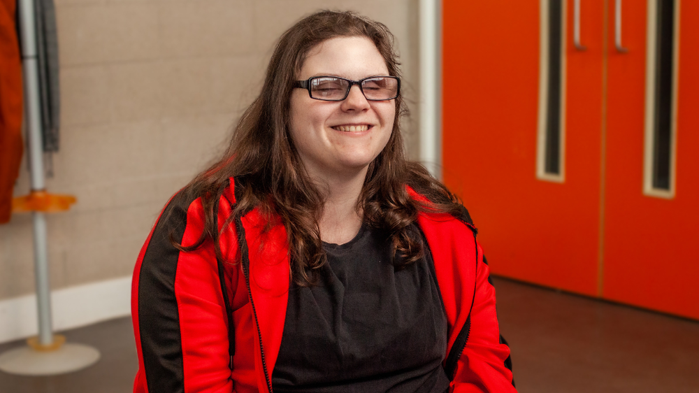A woman sitting on a chair smiling