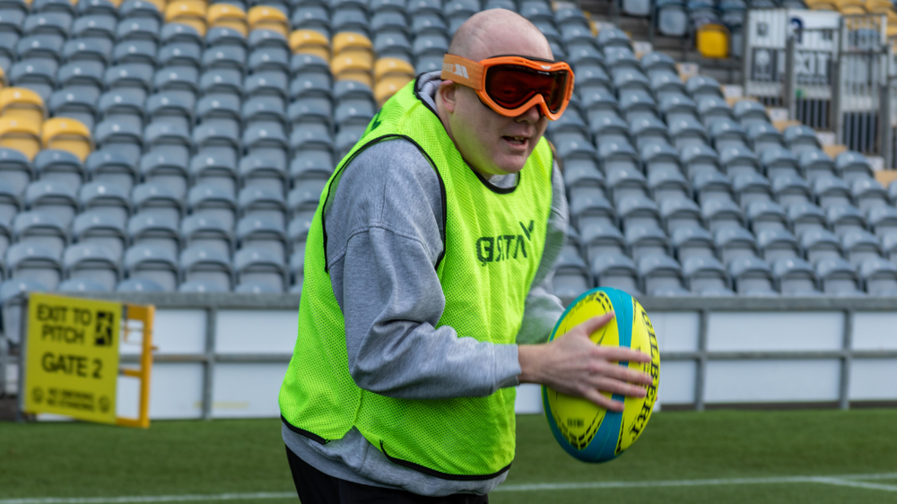 A man playing visually impaired rugby.