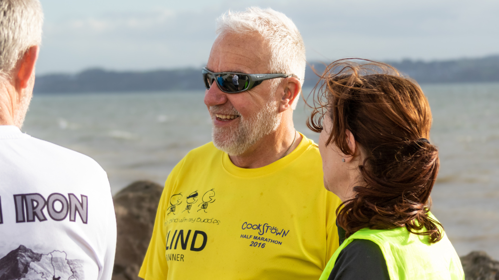 A man standing with a woman and another man